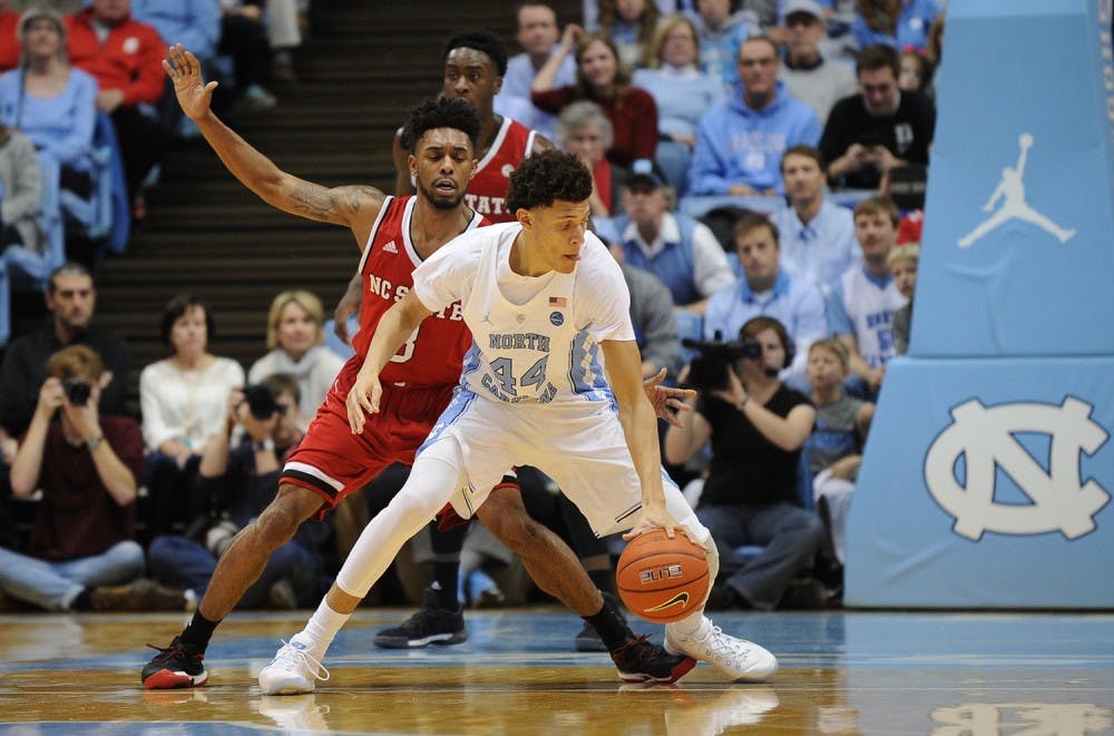 UNC forward Justin Jackson (44) dribbles around an N.C. State defender. The Tar Heels face Florida State on Saturday in Chapel Hill.&nbsp;
