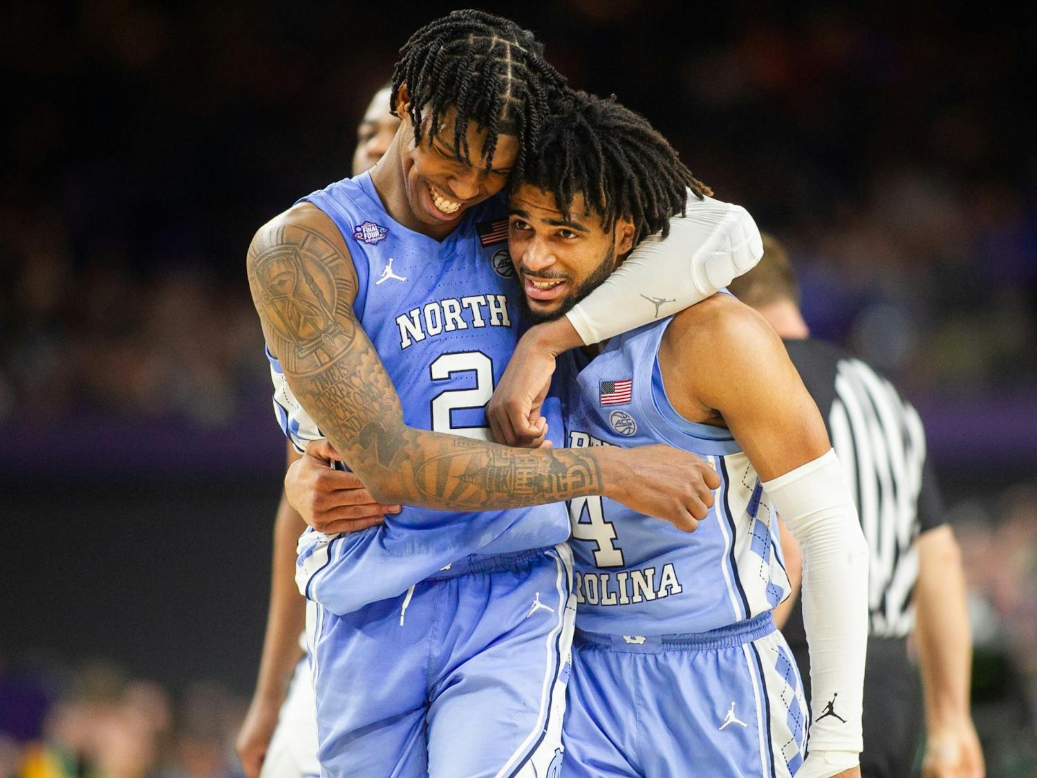 UNC sophomore guards Caleb Love (2) and RJ Davis (4) embrace after Love edged North Carolina forward with seconds left during the Final Four of the NCAA Tournament against Duke in New Orleans on Saturday, April 2, 2022. UNC won 81-77.