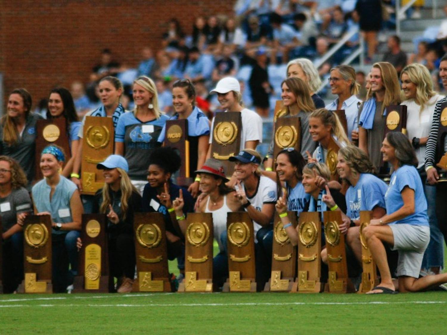 UNC women's soccer alumna pose for a picture after being recognized during halftime at the game against Duke on August 25, 2019. UNC beat Duke 2-0.