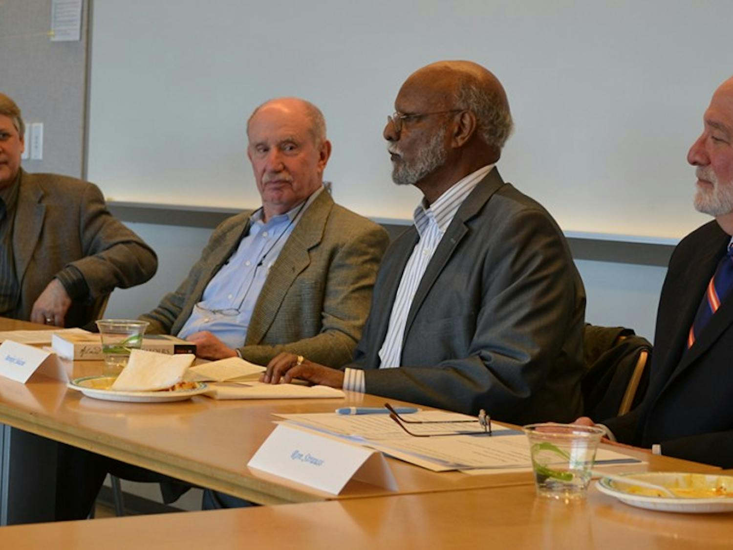 Panelists - from left to right - Michael Lambert, Ken Brown, Bereket Selassie, and Ron Strauss, talk at the First Installment of the Nelson Mandela Lunch Panel Discussion on Monday afternoon in the Fed Ex Global Center.