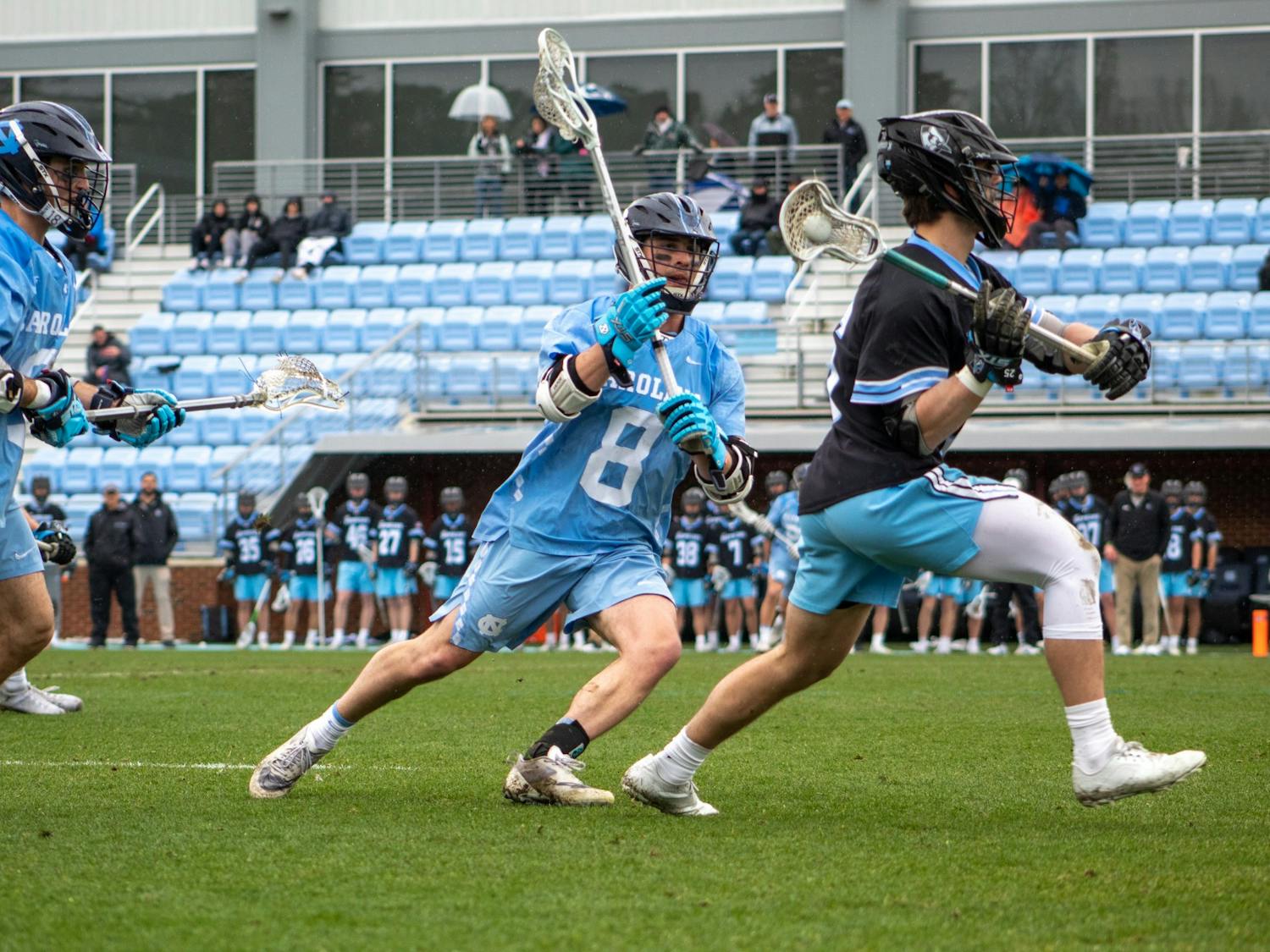 Senior attackman Nicky Soloman (8) attacks from behind in the Feb. 27 men's lacrosse game against Johns Hopkins University. UNC won 15-9.
