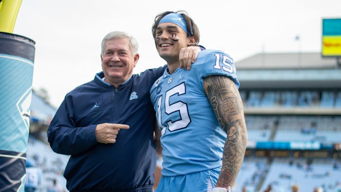 Senior wide receiver Beau Corrales (15) embraces head coach Mack Brown for senior day at the game against Wofford on Nov. 20, 2021 at Kenan Stadium. 
