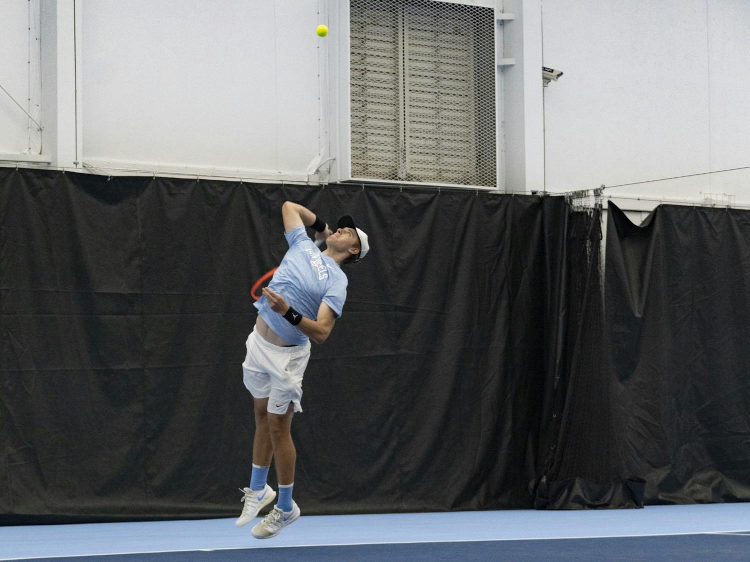 UNC graduate tennis player Ryan Seggerman jumps to hit the ball during his singles home matchup against Duke at Cone-Kenfield Tennis Center on Saturday, April 8, 2023. UNC fell to Duke 5-2.
