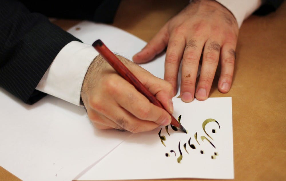 This was the Nowruz Persian New Year Celebration in Wilson Library. The event was from 5:45pm-7:30pm. Majid Roohafza was the calligrapher at the event. He is from Durham. He has done Persian Calligraphy since he was 9 years old. At the event he wrote different things (all themed around Nowruz) for people to take home for free. He has some pieces in the Hanes Art Center. He mentioned that he is both engineer and calligrapher. 