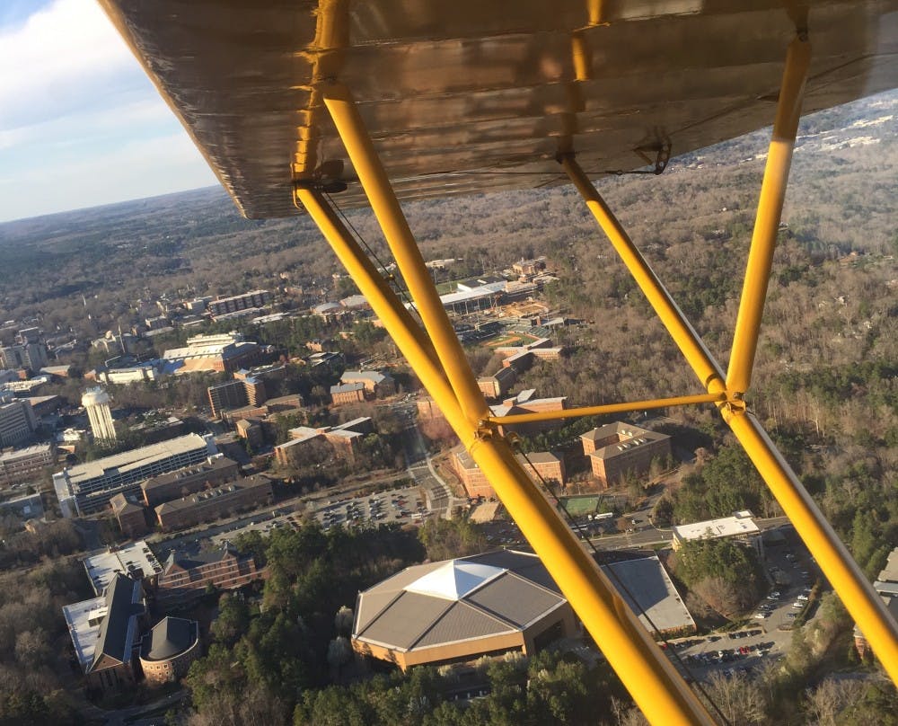 <p>A view of the Dean Dome and South Campus is seen from the Piper Cub.</p>
