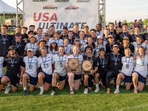 UNC women’s Ultimate Frisbee team, Pleiades, and UNC men's Ultimate Frisbee team pose at the 2022 USA Ultimate D-I College Championships in Milwaukee, Wis. On May 30, 2022, both teams secured unprecedented repeat championships. Photo courtesy of Brian Whittier.
