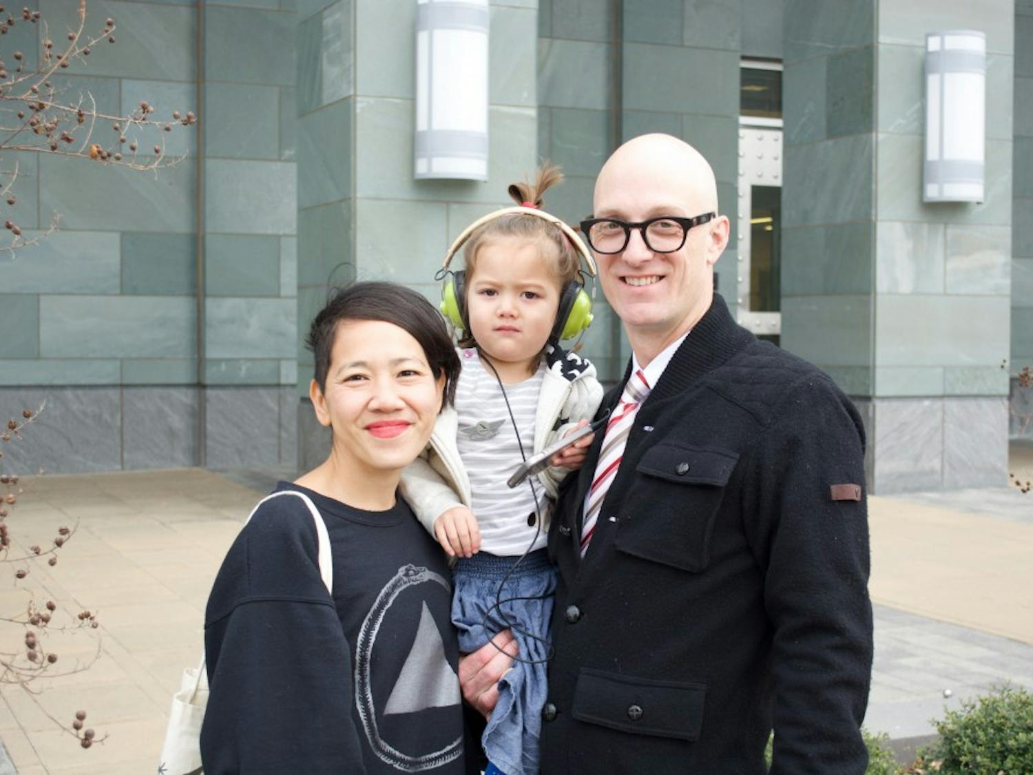 UNC Asian studies teaching assistant professor Dwayne Dixon poses with his family outside the Durham County Courthouse. Dixon, who is charged with bringing a weapon to a demonstration, had his case postponed until Feb. 8.