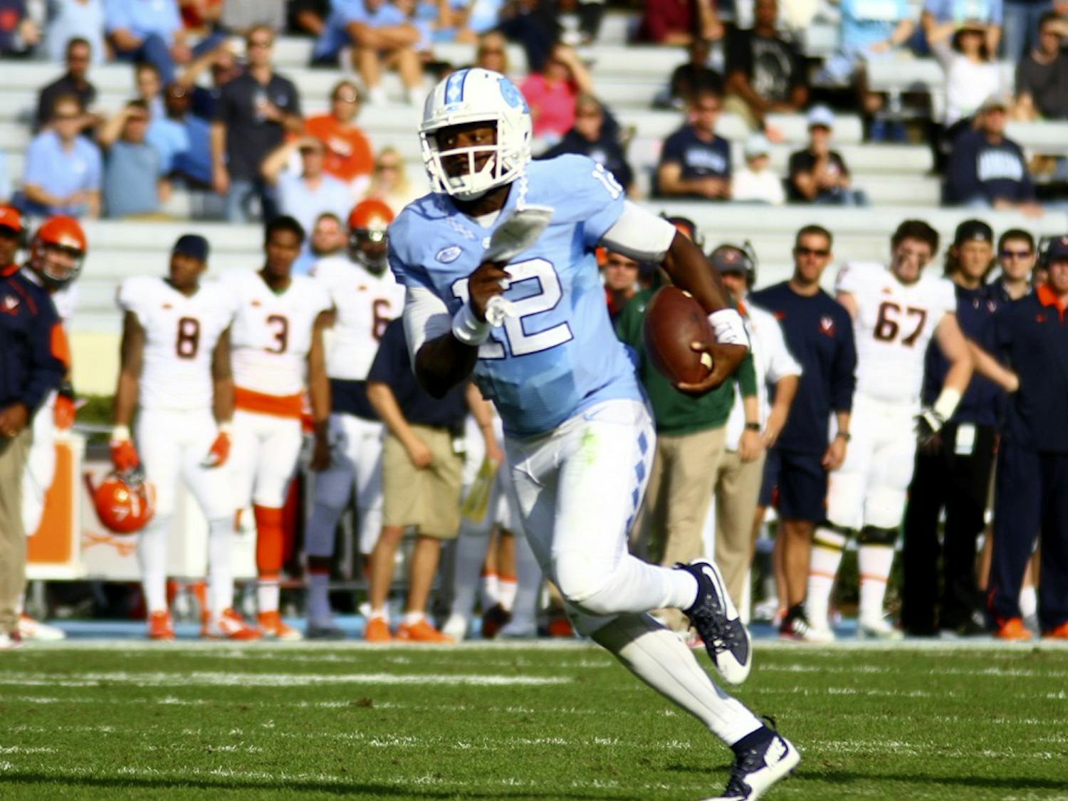 Marquise Williams (12) runs the ball in UNC's win over Virginia on Saturday. Williams netted 71 rushing yards during the game.&nbsp;