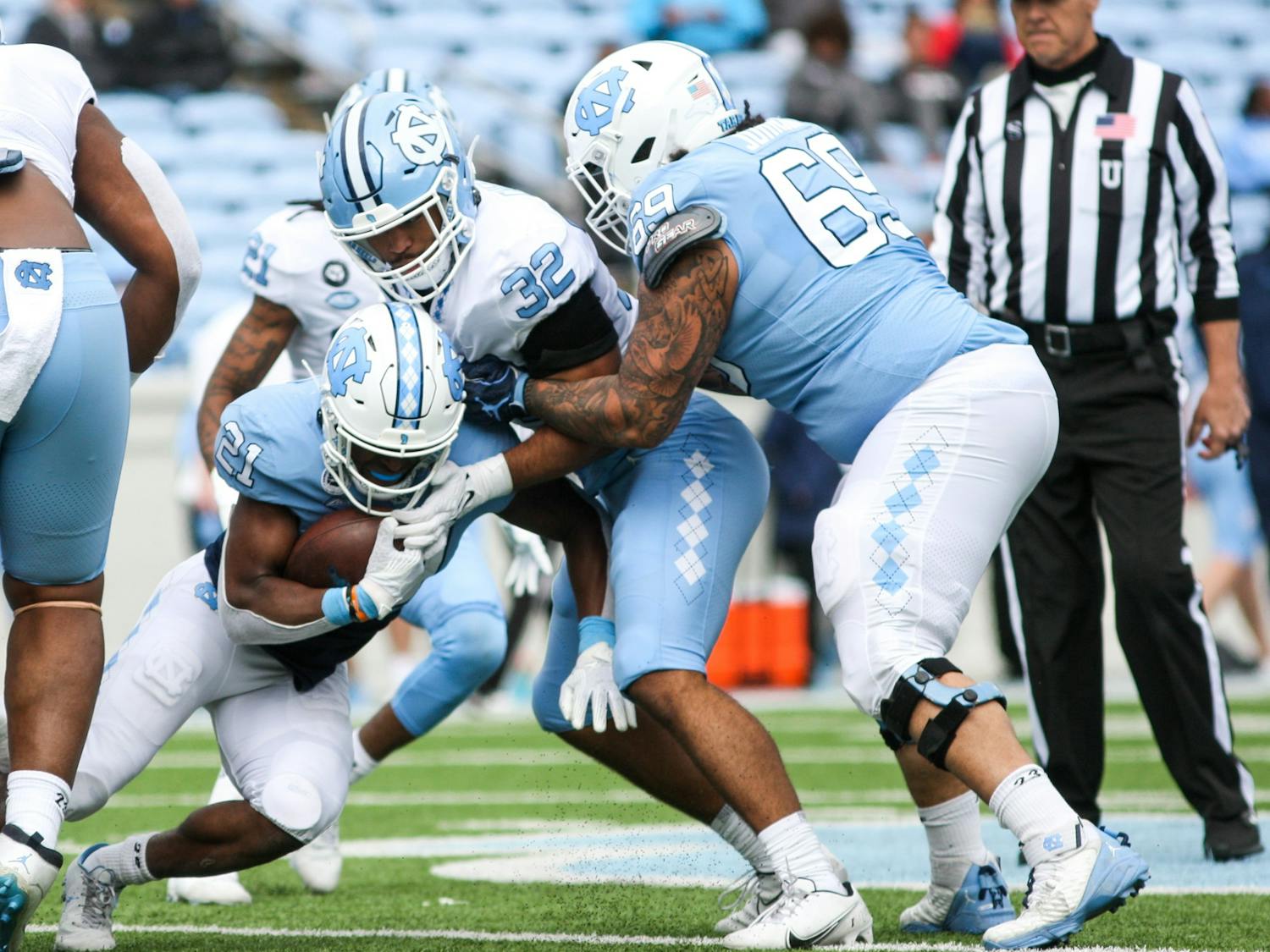 Sophomore running back Elijah Green (21) powers through the defensive line in the Spring Game on Saturday, April 9, 2022. The Tar Heels and Carolina tied, 14-14.