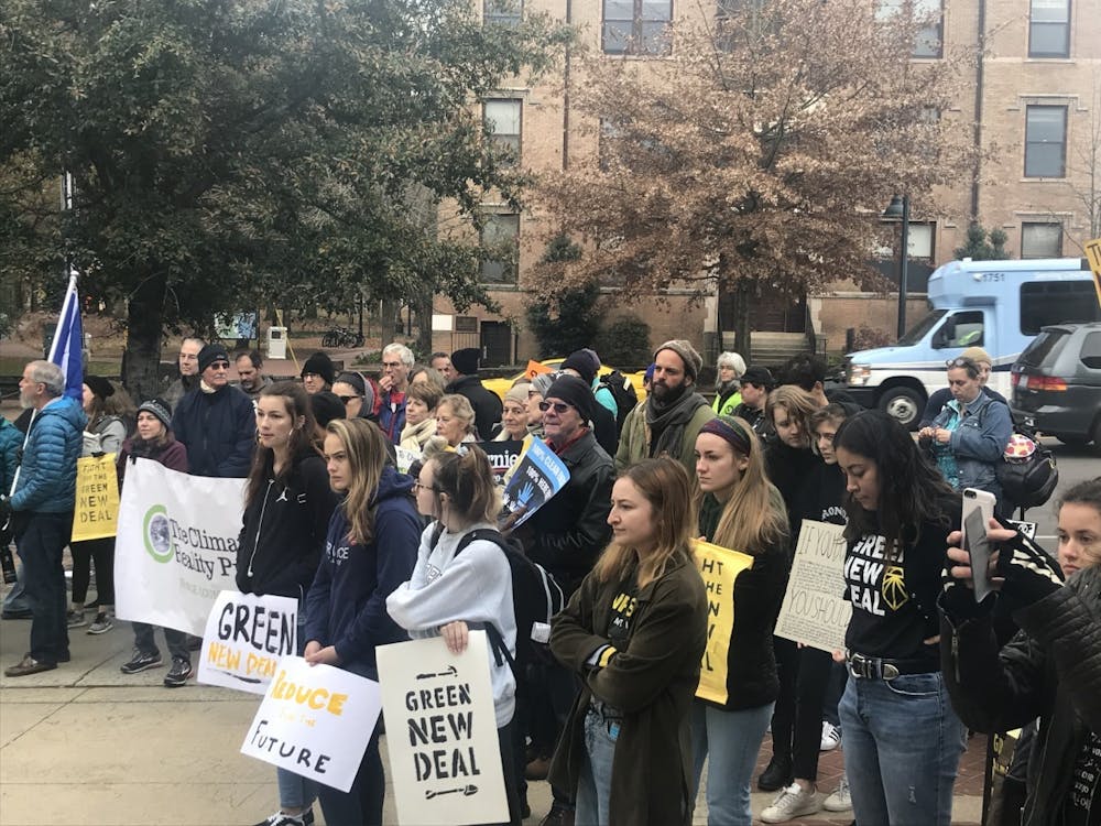 Members of the Chapel Hill & Carrboro Sunrise Movement hub stand in the Peace and Justice Plaza in Chapel Hill on Friday, Dec. 6, 2019 to demand that the Chapel Hill Town Council supports a national Green New Deal and large-scale climate action. Photo by UNC sophomore Ella Carter, one of the hub coordinators. 