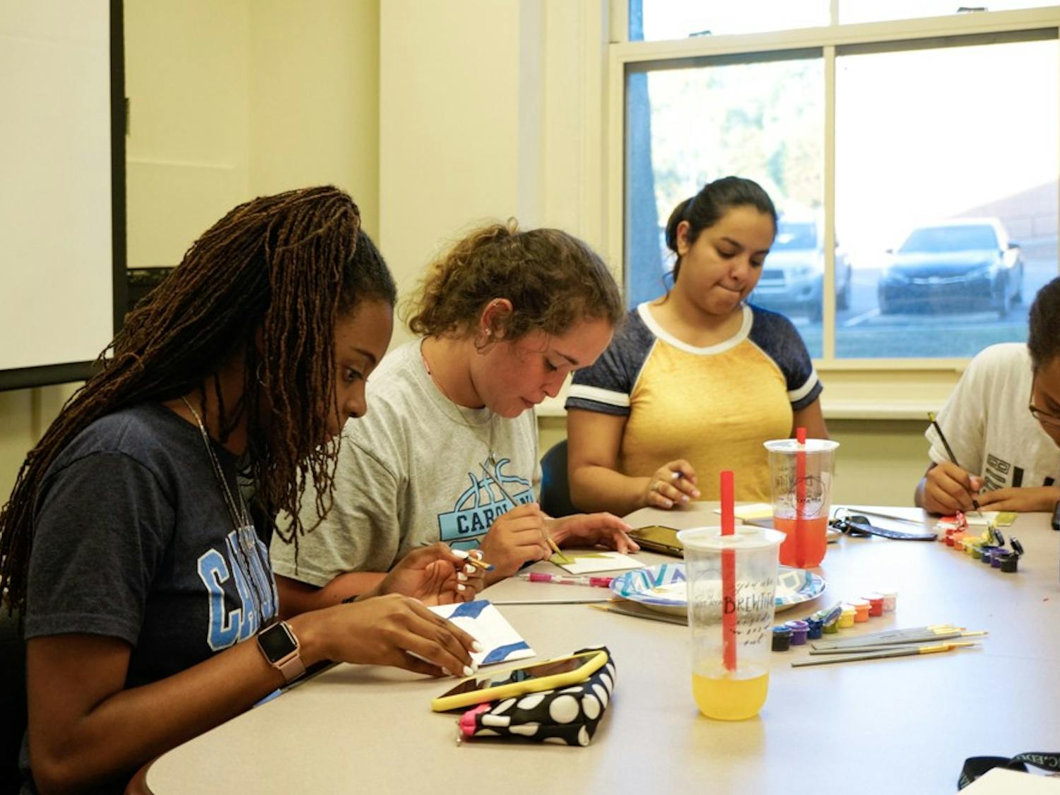 On September 23rd at the Carolina Latinx Center, students (left to right) Jadah Smith, Isabella Lima, Elena Delvalle, and Bianca Goodwin participate in "Paint My Latinidad" by each painting a visual representation of their latinidad. This event was one of many hosted by the Carolina Latinx Center as a way to celebrate Latin Heritage Month and raise conversations about Latinx culture.