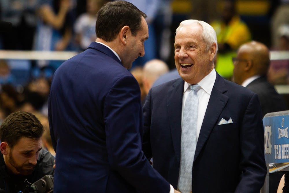 Duke's head coach Mike Krzyzewski (left) and North Carolina's head coach Roy Williams (right) greet each other at halftime during the game against Duke in the Smith Center on Wednesday, Feb. 8, 2020.  UNC lost to Duke 98-96.
