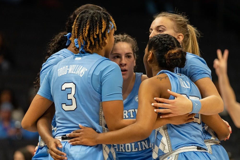 <p>UNC huddles up before a free throw during the women’s basketball game against Michigan in the Jumpman Invitational at the Spectrum Center on Tuesday, Dec. 20, 2022.</p>