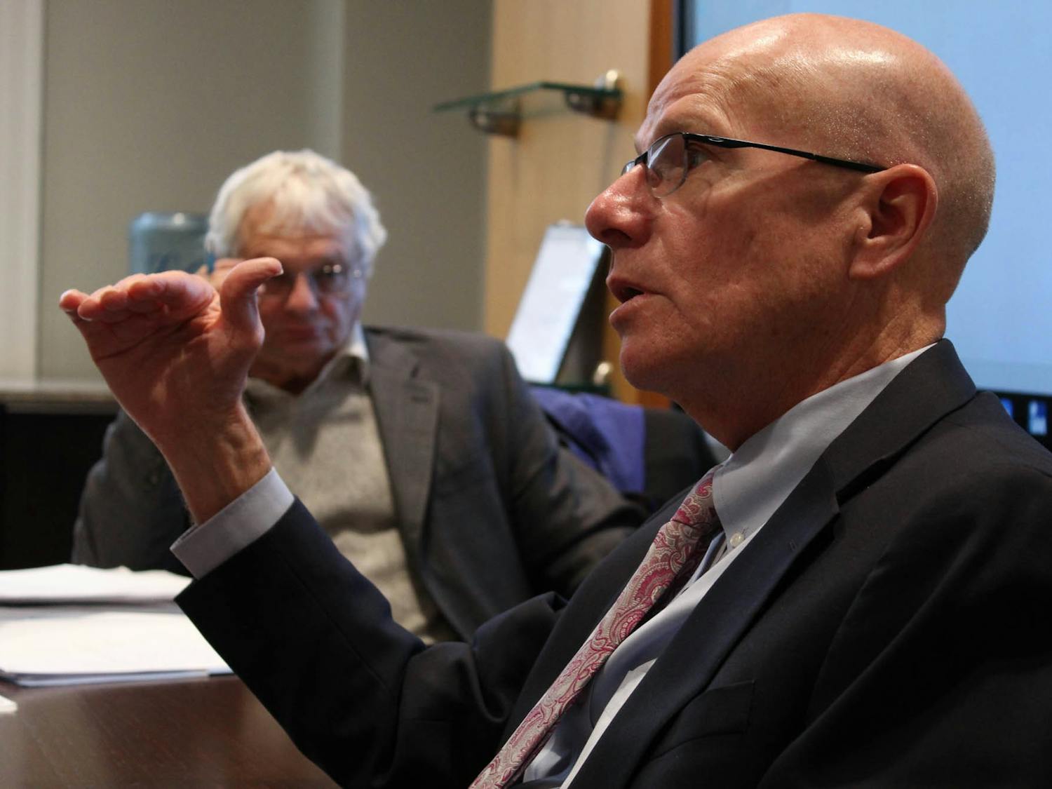 Executive Vice Chancellor and Provost Robert A. Blouin (front) and Chairperson of the Faculty Lloyd Kramer discuss lagging faculty salaries during the Faculty Executive Committee's meeting on Monday Jan. 27, 2020.