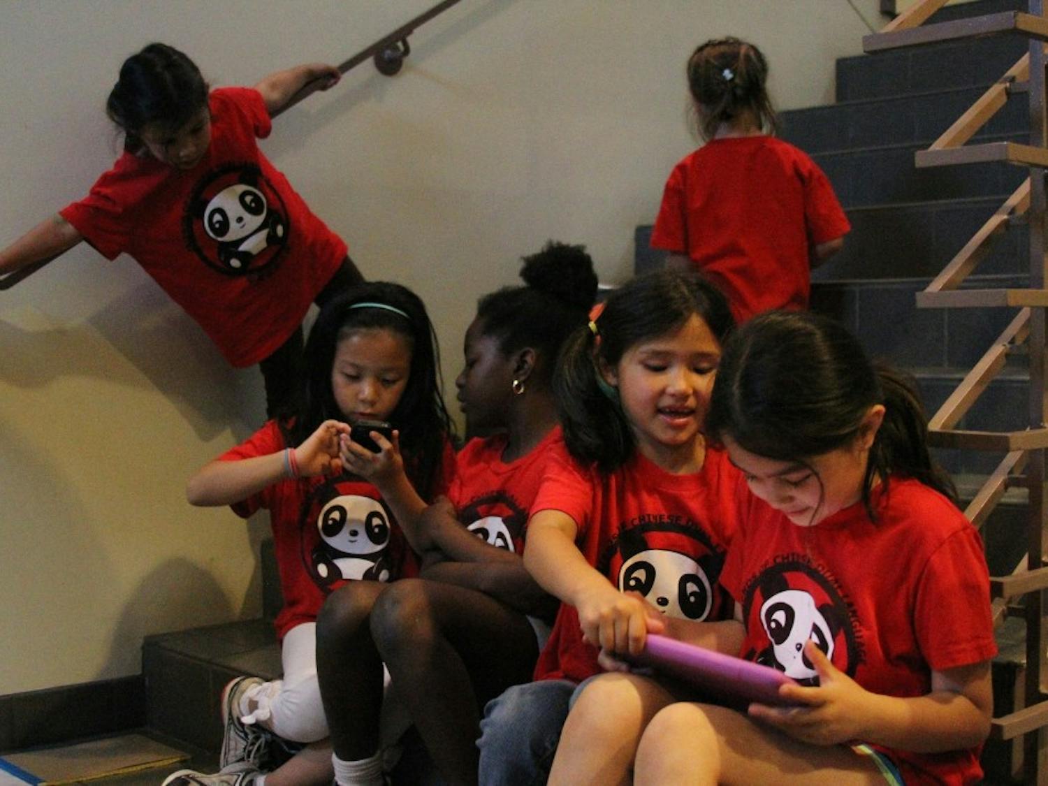 Students from Glenwood Elementary School’s Friends of Chinese Dual Language program play outside of the heavily attended Chapel Hill- Carrboro City Schools meeting on May 17, 2012 about dual language.