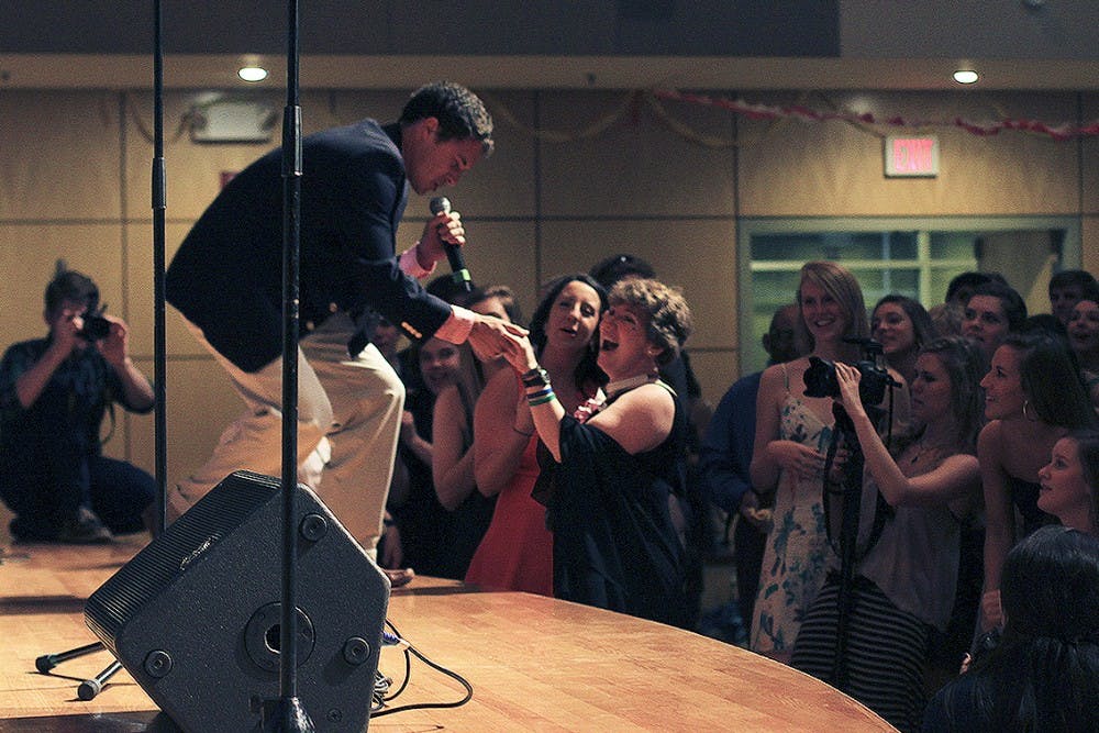 Michael Batres of the UNC Achordants sings to Lana Morgan at the Joy Prom in the Great Hall of the Union on Thursday.