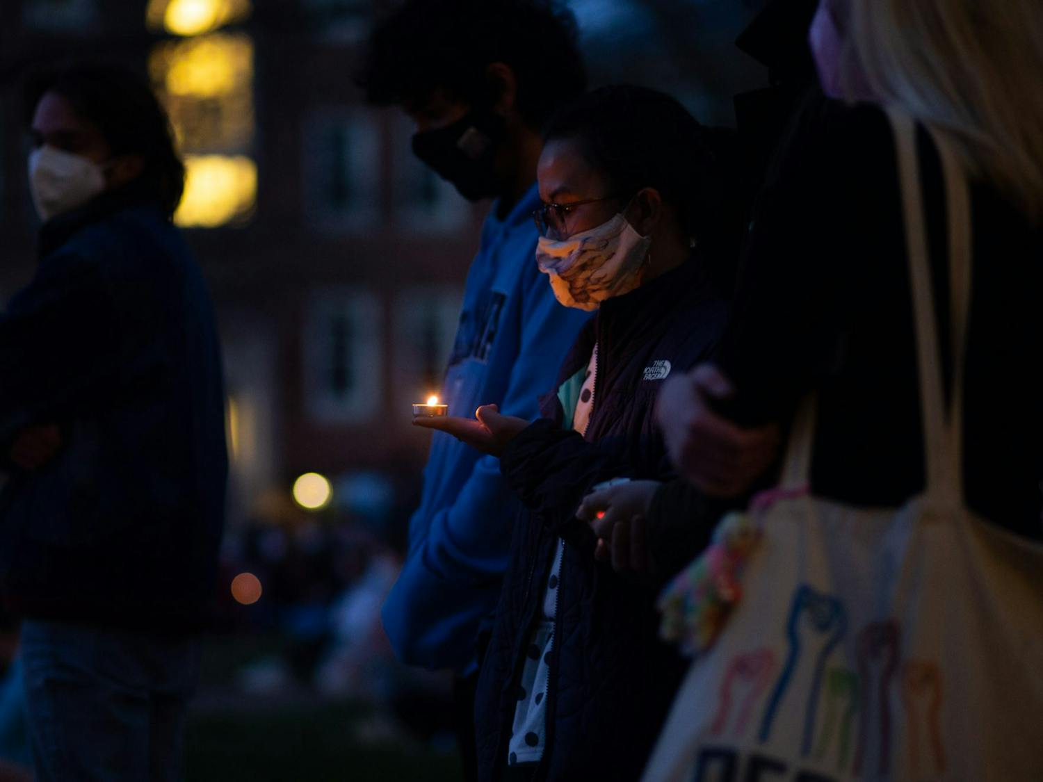 Students share a moment of silence at the Campus Y on Sunday, March 21, 2021during a vigil in honor of the lives lost during a shooting in Atlanta. 