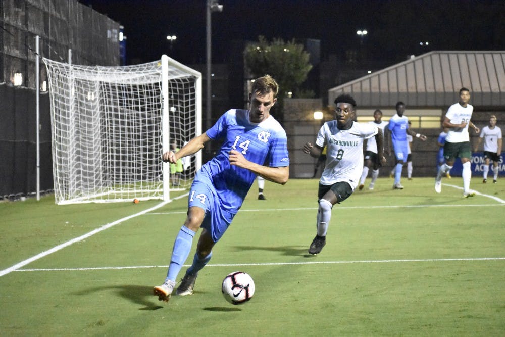 Senior forward Nils Bruening (14) dribbles the ball outside the penalty box in UNC's 2-0 win over Jacksonville on Sept. 3 at Koskinen Stadium.