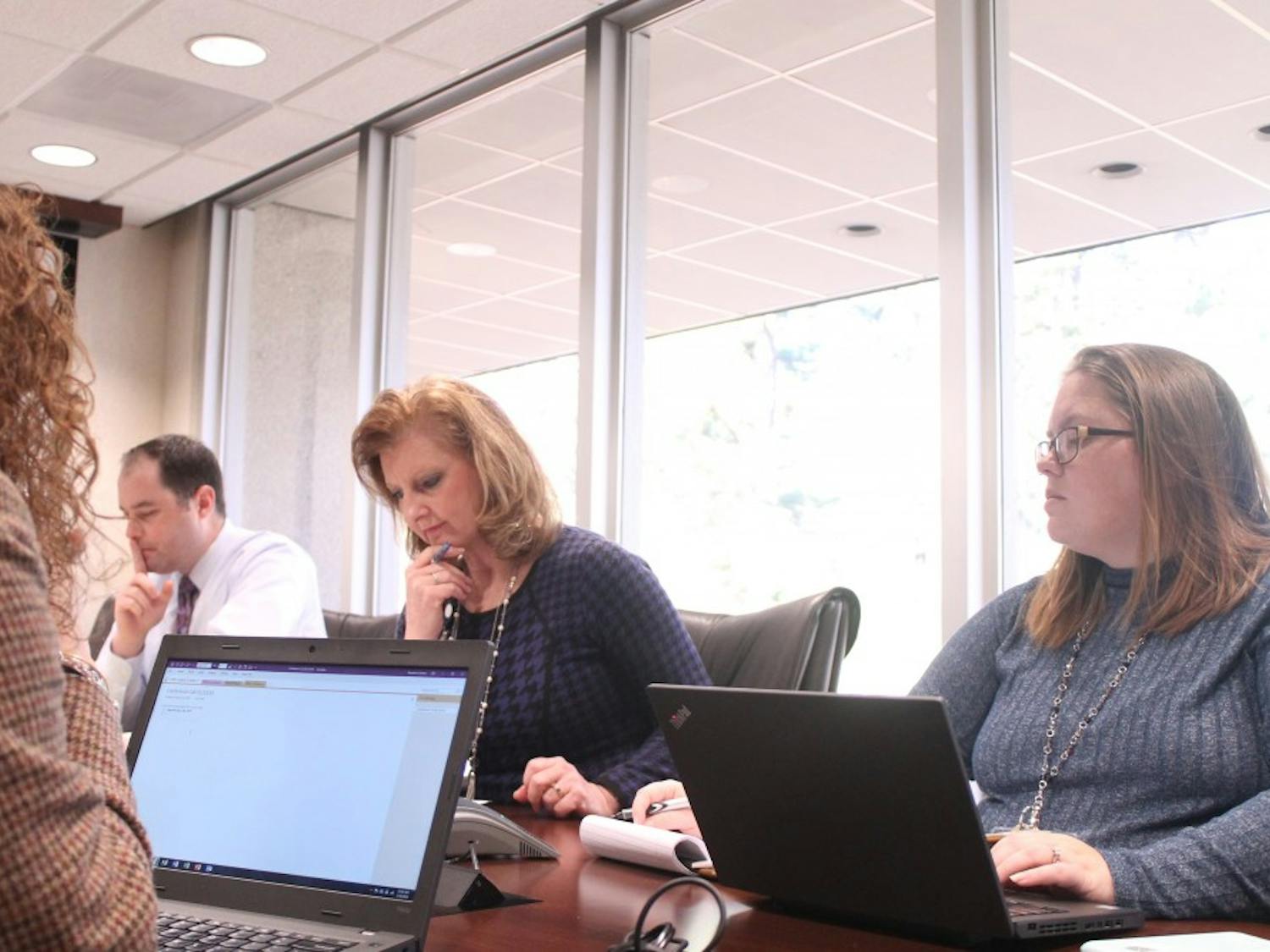 Ed Purchase (left), Lynne Sanders (center) and Heather Hummer (right) discuss logistics of their yearly conference at C.D. Spangler Building in Chapel Hill, NC on the morning of Thursday, Jan. 10, 2019.&nbsp;