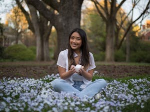 Junior Advertising and Public Relations major Tran Nguyen holds her bowl of crystals in the Coker Arboretum on Thursday, Apr. 1, 2021.
