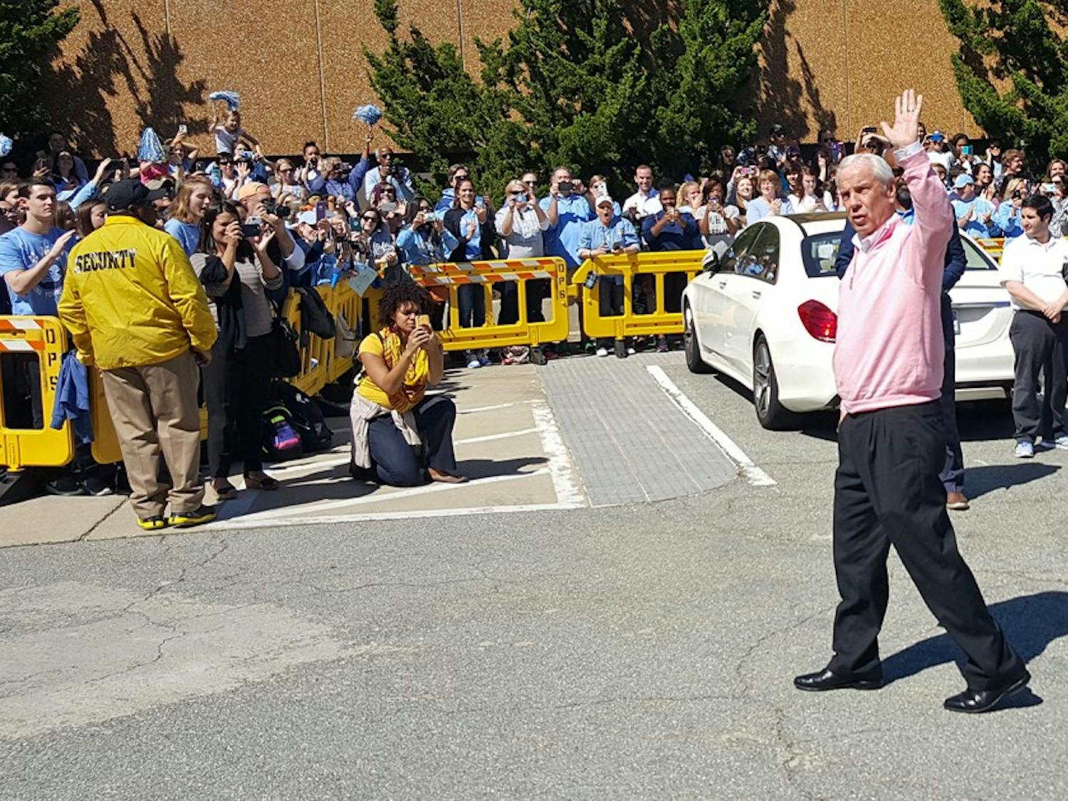 Coach Roy Williams waves at the crowd after UNC men's&nbsp;basketball&nbsp;returned from Houston on&nbsp;Tuesday.