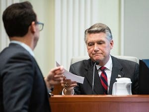 Josh Lawson, chief counsel for the state Board of Elections and Ethics Enforcement, left, hands Mark Harris, Republican candidate in North Carolina's 9th Congressional race, a document during the fourth day of a public evidentiary hearing on the 9th district's voting irregularities investigation on Thursday, Feb. 21, 2019, at the North Carolina State Bar in Raleigh, N.C. (Travis Long/Raleigh News & Observer/TNS)