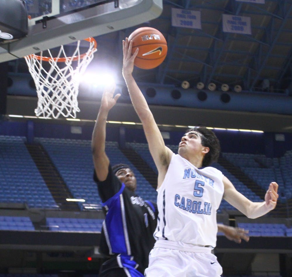 North Carolina JV guard Robbie O'Han (5) goes up for a lay in Tuesday night.
