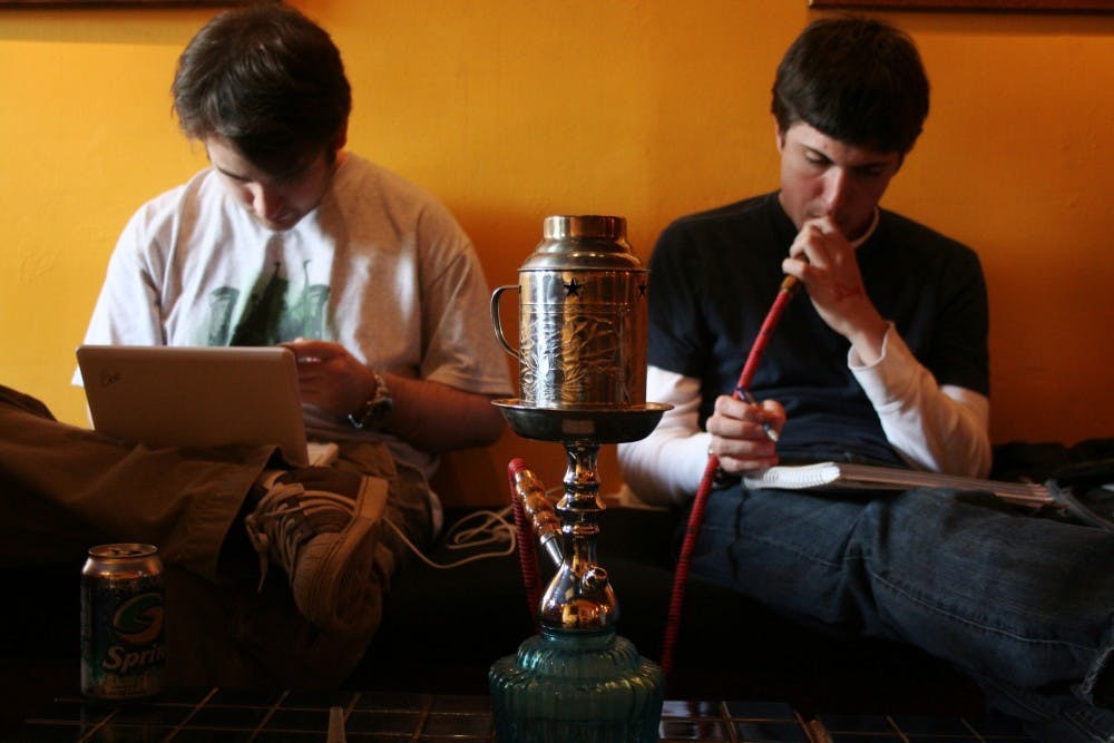 Matt Scott" a junior English major and Drew Dimmery a junior international studies major share a hookah while studying at Hookah Bliss on Monday afternoon.Now that a new anti-smoking bill has been ratified Hookah Bliss will have to close its doors in January owner Adam Bliss said.
