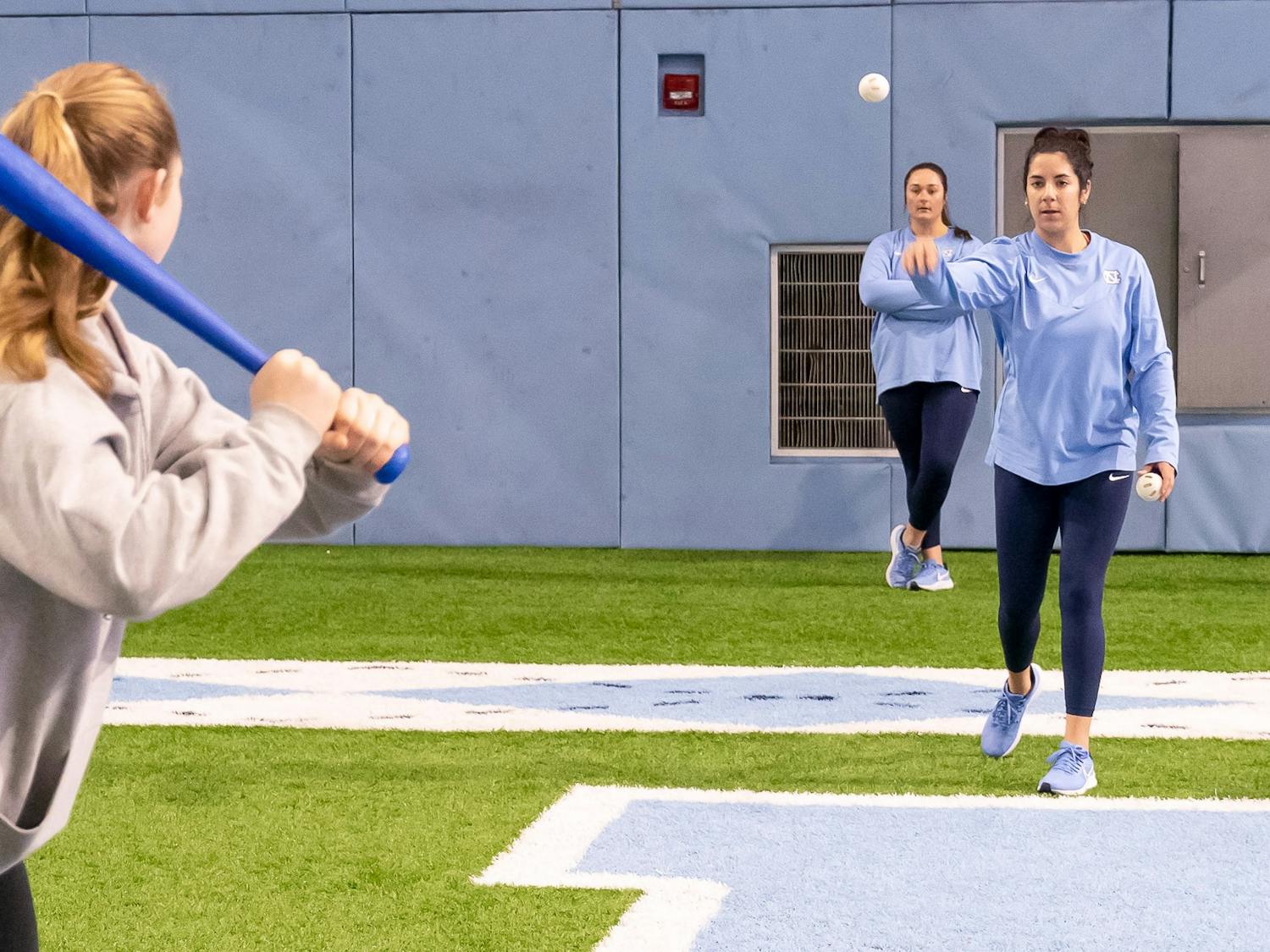 UNC fifth-year softball player Kiersten Licea throws the ball to Maddy Russell at the National Girls & Women in Sports Day event held at the Bill Koman Practice on Sunday, Jan. 22, 2023.