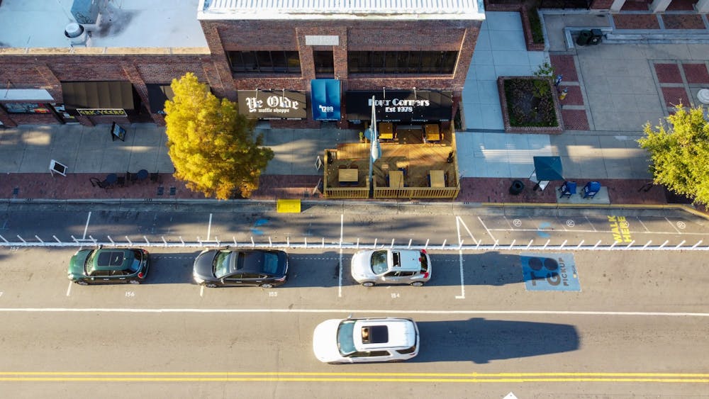 <p>Cars drive down Franklin Street on Monday, Oct. 26, 2020 outside of Four Corners, which has built outdoor seating to accommodate for the pandemic but poses some accessibility problems.&nbsp;</p>