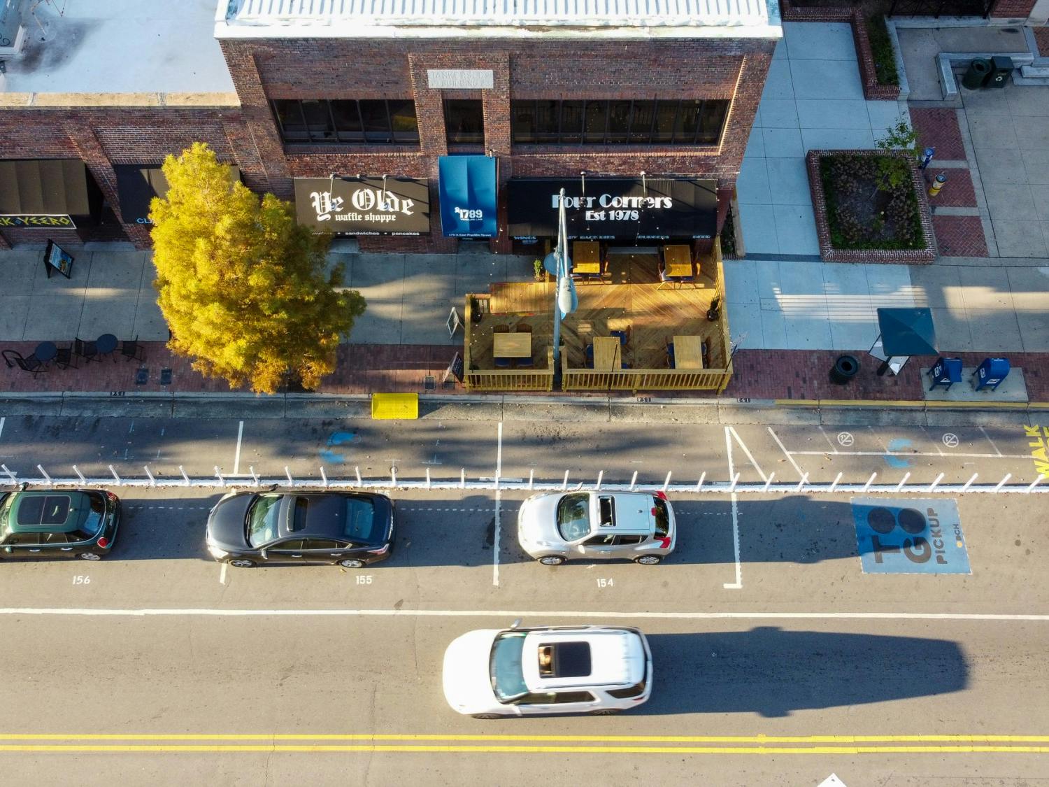 Cars drive down Franklin Street on Monday, Oct. 26, 2020 outside of Four Corners, which has built outdoor seating to accommodate for the pandemic but poses some accessibility problems.&nbsp;