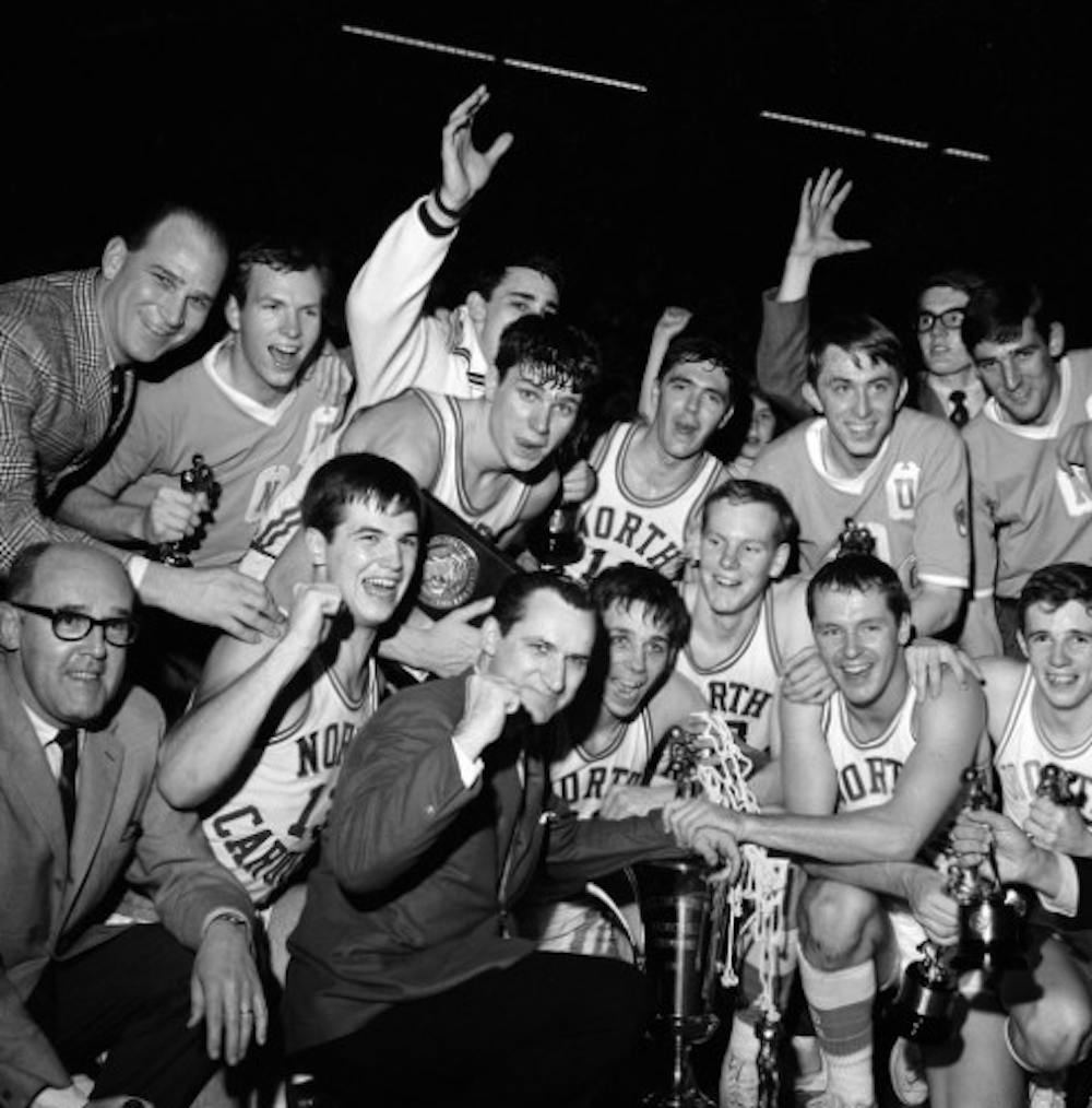 	<p>The men&#8217;s basketball team celebrates their win over Duke University at the finals of <span class="caps">ACC</span> tournament in Greensboro, NC, on March 11, 1967. Among those pictured are Head Coach Dean Smith (front row, third from left) and <span class="caps">ACC</span> tournament <span class="caps">MVP</span> Larry Miller (front row, fourth from left). Photographer Hugh Morton. Courtesy of North Carolina Collection, University of North Carolina at Chapel Hill Library.</p>