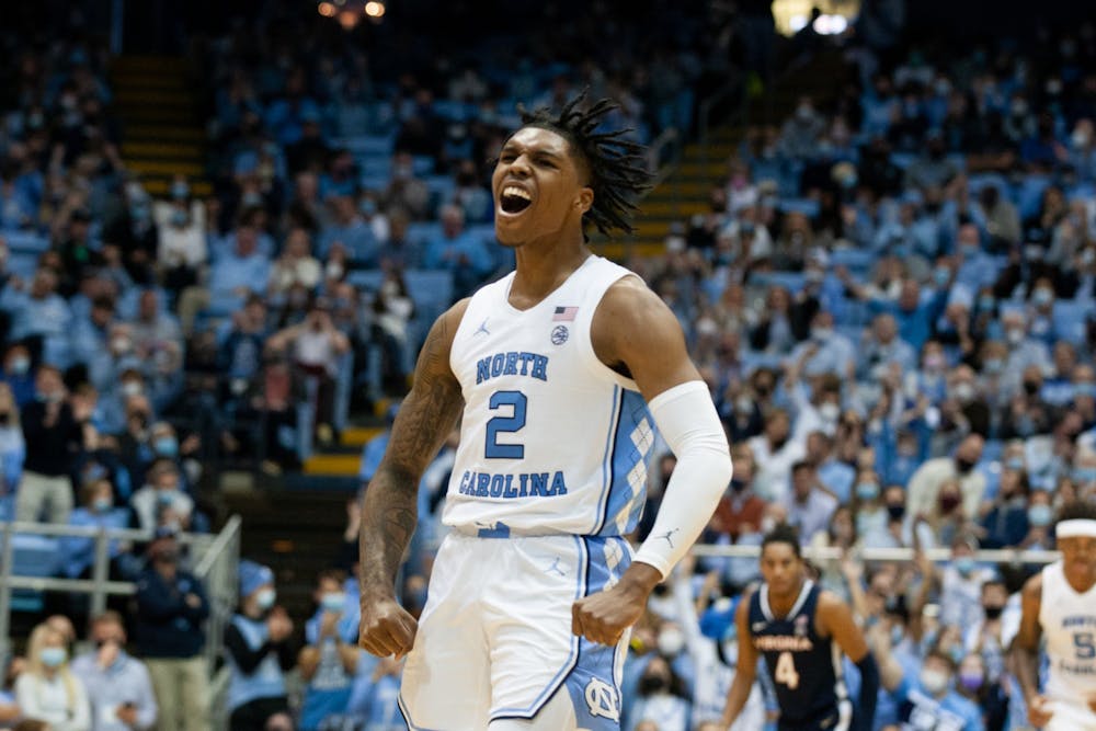 Sophomore guard Caleb Love (2) cheers after scoring at the game against Virginia at the Smith Center in Chapel Hill on Jan. 8, 2022. UNC won 74-58.