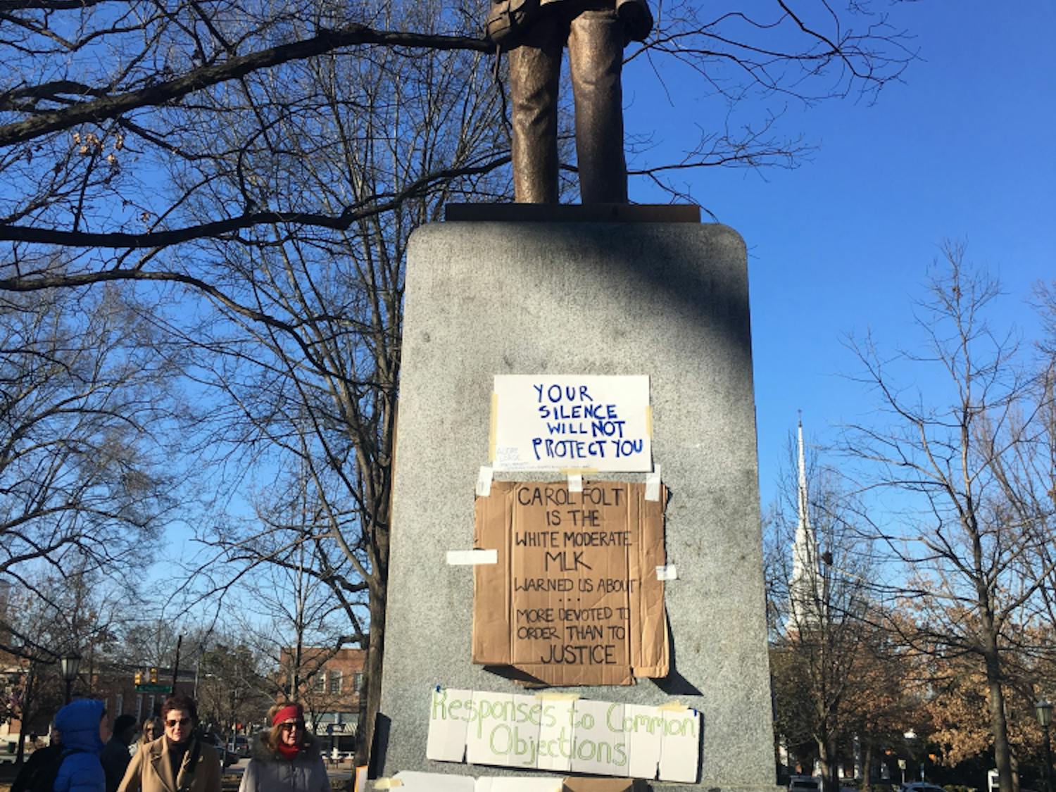 Signs taped to the base of Silent Sam in January 2018 reproached University administrators for their actions regarding the Confederate memorial. 
