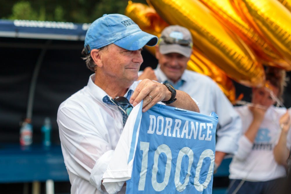 <p>Women's soccer head coach Anson Dorrance displays the soccer jersey made for him after Sunday's game, which marked his 1000th career victory.</p>