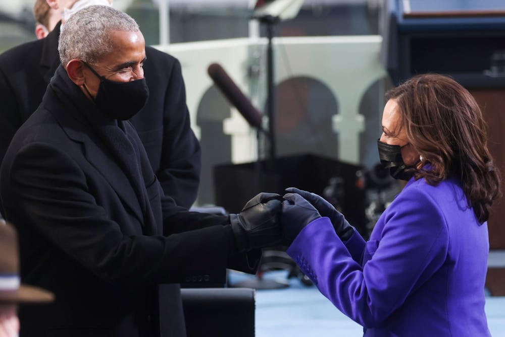Former US President Barack Obama (L) bumps fists with US Vice President-elect Kamala Harris as they arrive for the inauguration of Joe Biden as the 46th US President, on the West Front of the US Capitol in Washington, DC on January 20, 2021. PHOTO BY JONATHAN ERNST/POOL/AFP via Getty Images)