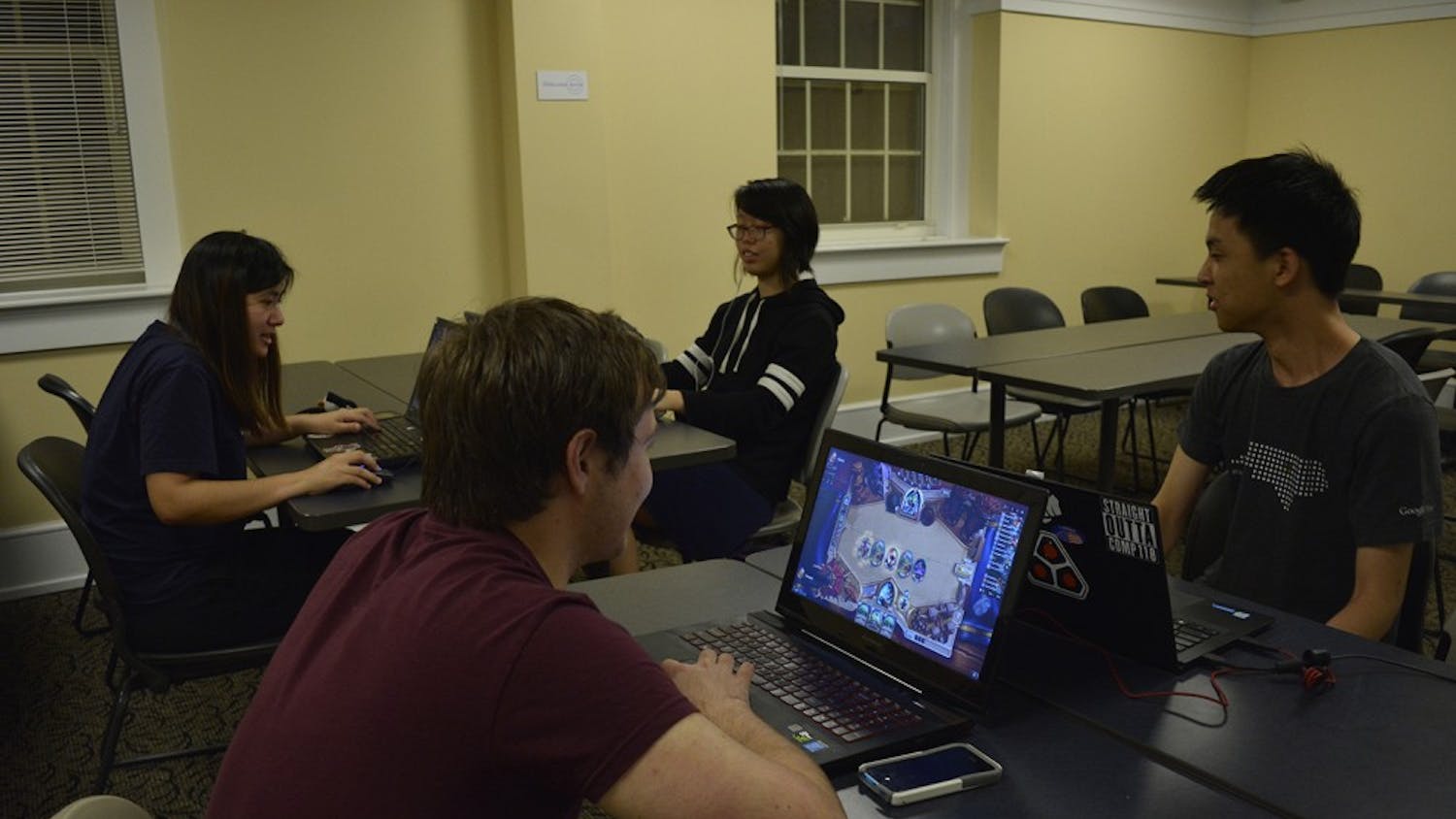 (From left) Joey Chau, Joe Plever (red shirt), Anne Chao (back right), and Cedric Nam play PC games at a UNC eSports meet up.