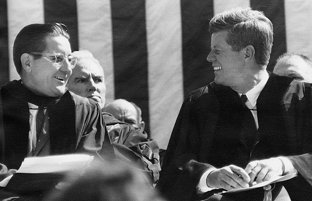 	<p>Bill Friday sits with President John F. Kennedy on stage at Kenan Stadium in 1961. President Kennedy came to <span class="caps">UNC</span> to speak on University Day. Courtesy of North Carolina Collection, <span class="caps">UNC</span>-CH</p>