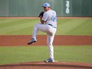 Redshirt sophomore Austin Love (44) prepares to pitch the ball in a game against Louisville on Friday, May 14, 2021. The Tar Heels beat the Cardinals 5-1.