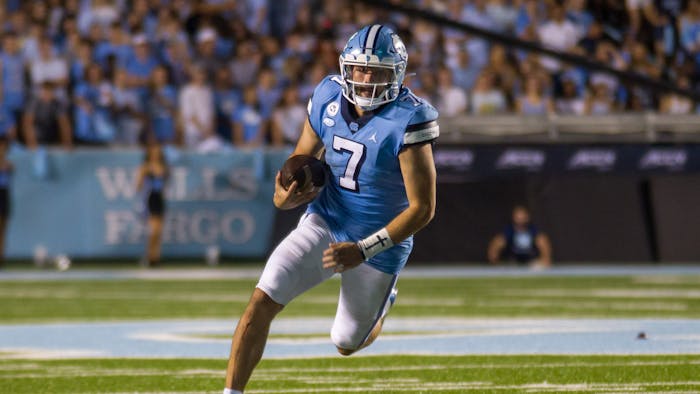 UNC junior quarterback Sam Howell (7) runs the ball down the field during the Tar Heels' home football matchup in Kenan Memorial Stadium on Sept. 18, 2021, against the University of Virginia Cavaliers. The Tar Heels won 59-39.