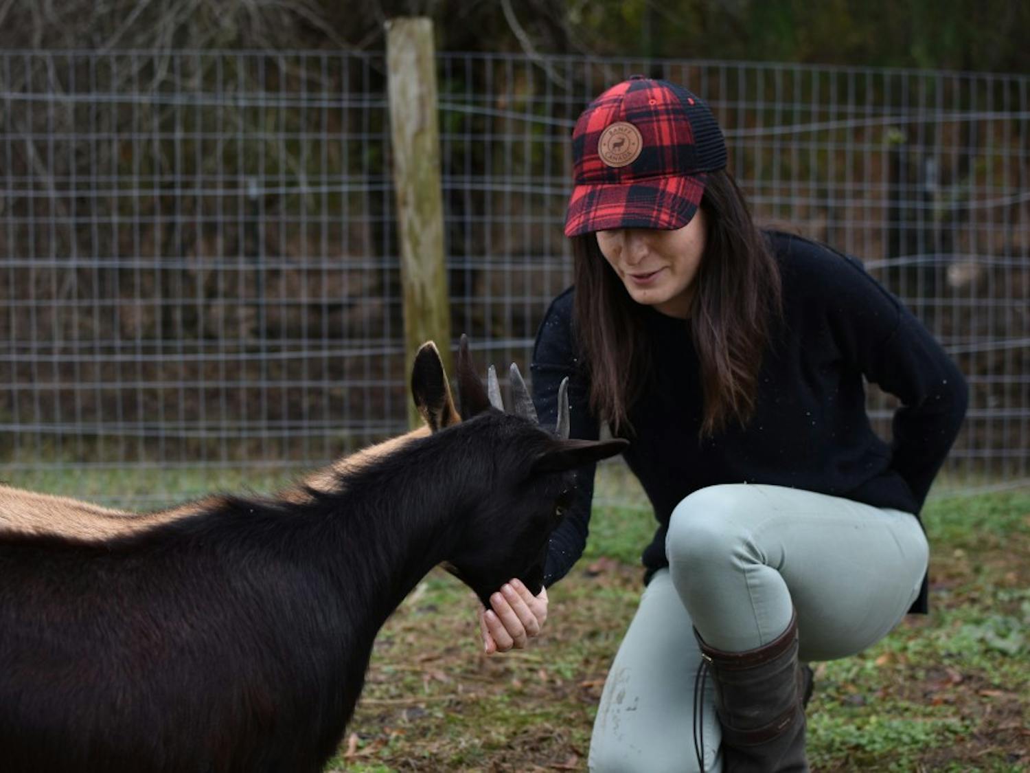 Lindsey Schwartz hand feeds goats at The 1870 Farm on Sunday, Nov. 25, 2018.