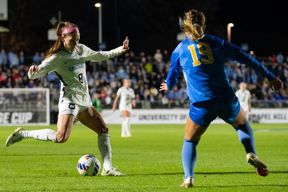 <p>UNC senior forward Emily Moxley (8) passes the ball during UNC's game against UCLA in the NCAA Finals at WakeMed Soccer Park on Friday, Dec. 5, 2022. UNC fell to UCLA 3-2.</p>