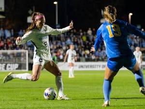 UNC senior forward Emily Moxley (8) passes the ball during UNC's game against UCLA in the NCAA Finals at WakeMed Soccer Park on Friday, Dec. 5, 2022. UNC fell to UCLA 3-2.