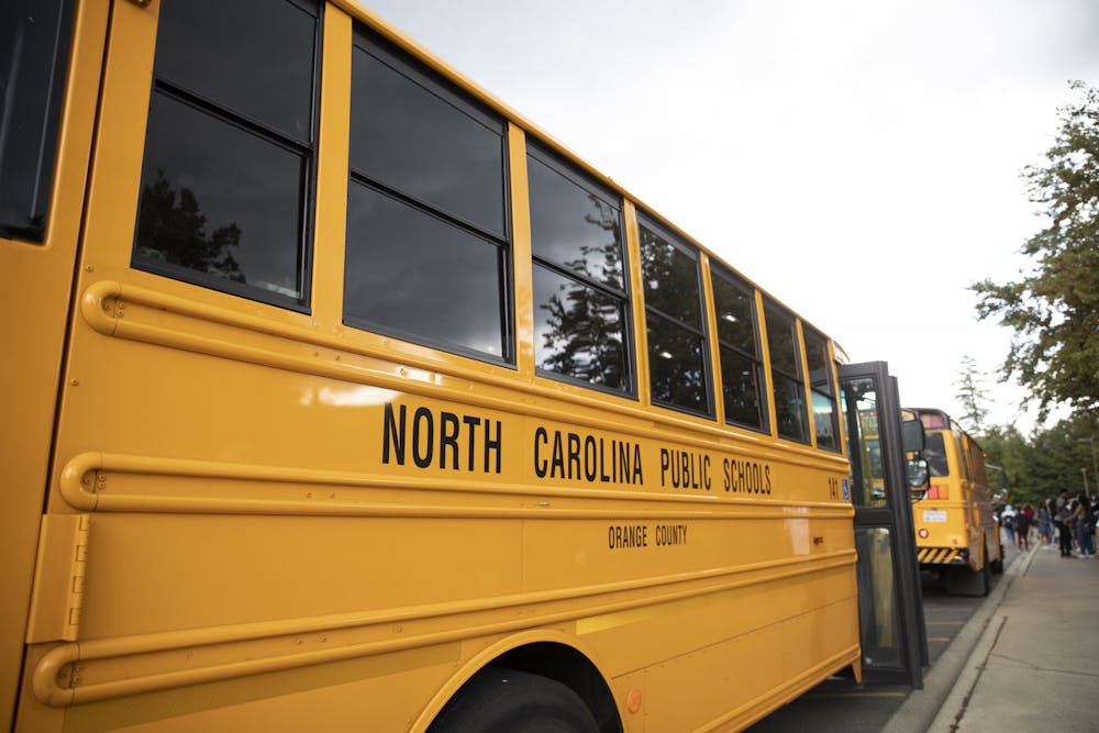 School buses await students at East Chapel Hill High School on Monday, Sept. 12, 2022.