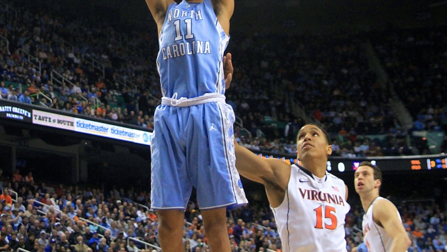 Junior forward Brice Johnson (11) dunks the ball in the first half. Johnson scored 13 points and grabbed six rebounds during Friday night's matchup against Virginia.