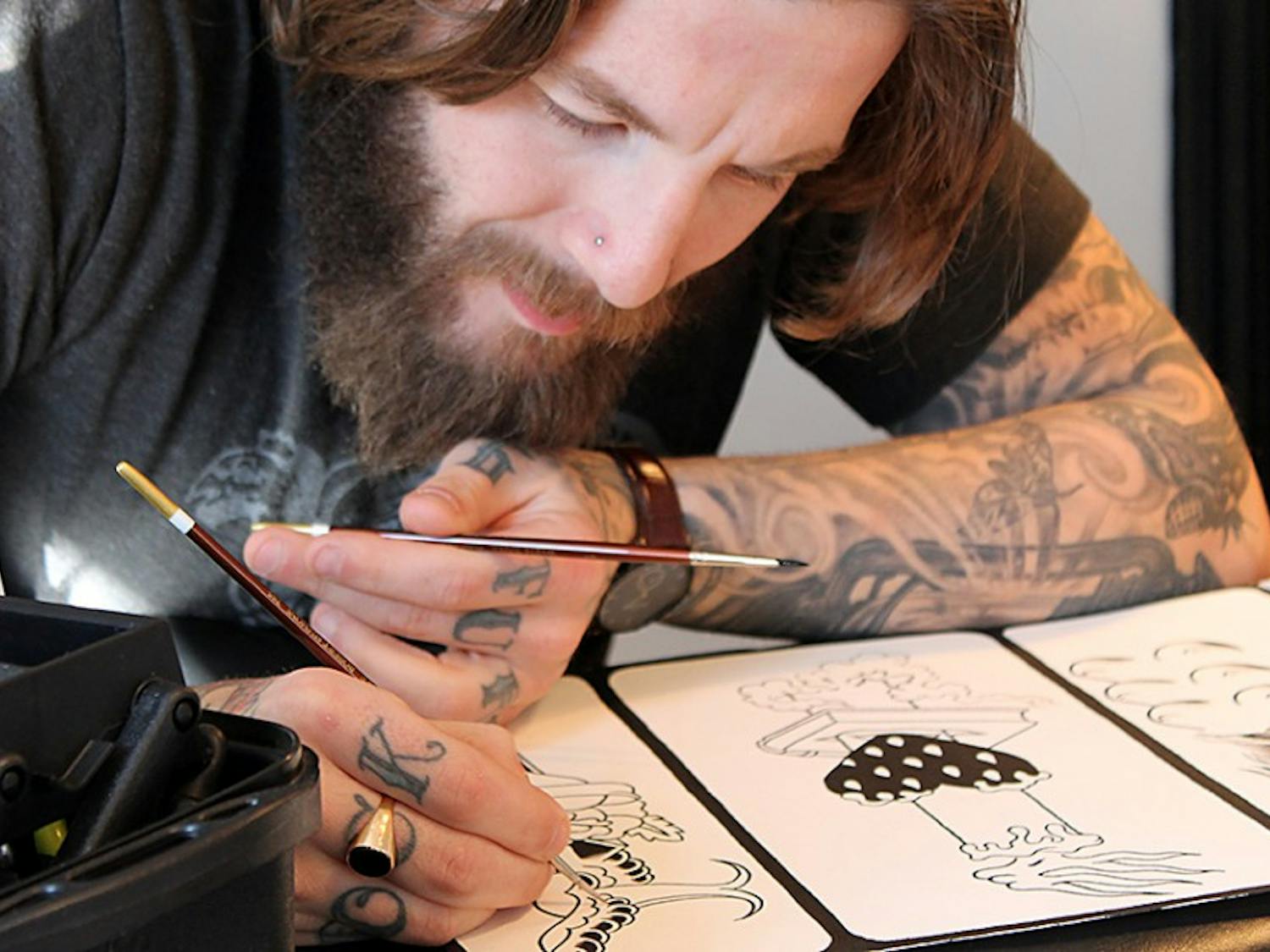 Mike Wheeler, an artist at Ascension Tattoo on Franklin Street, prepares tattoo stencils. 