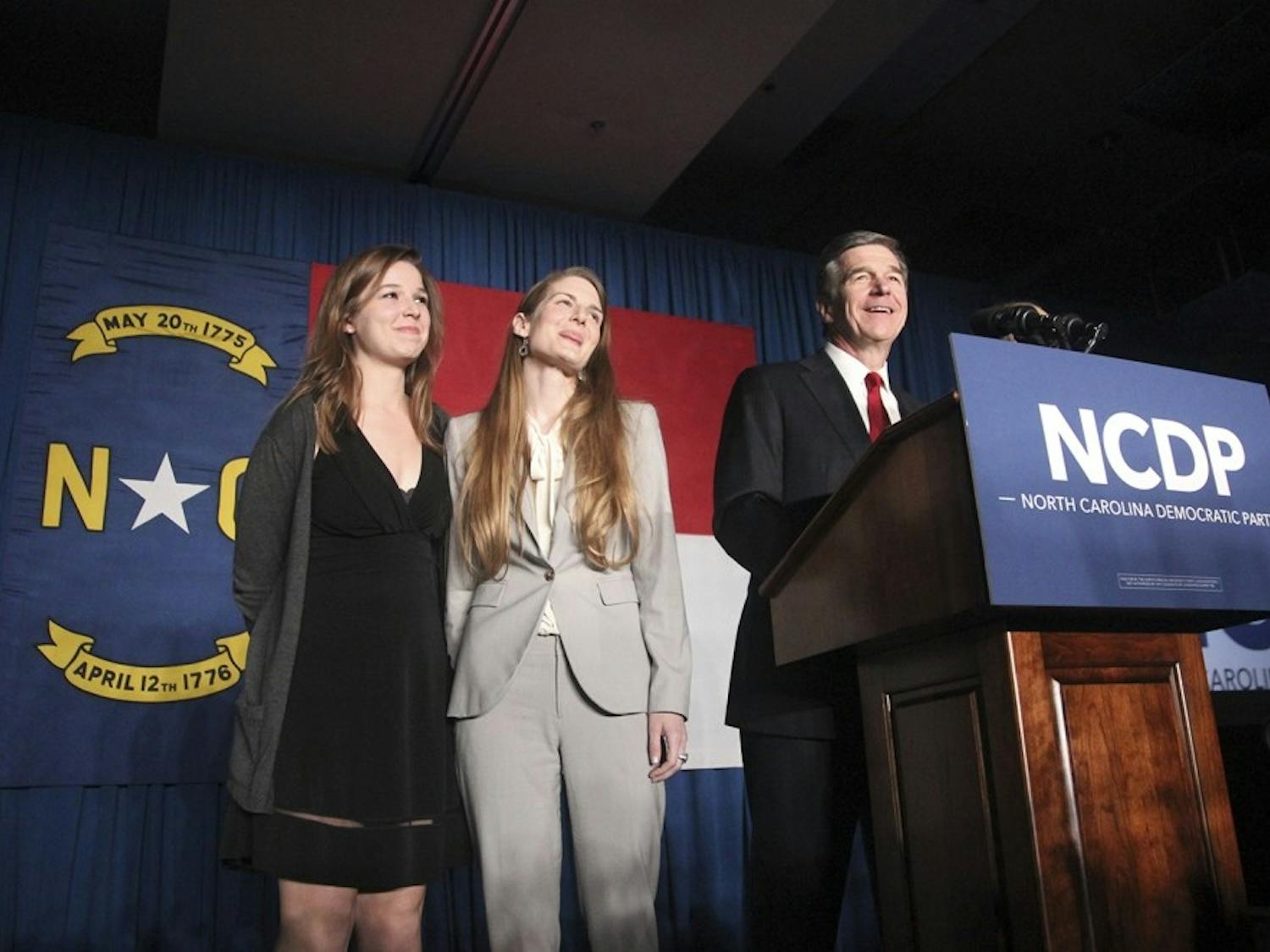 North Carolina Governor-elect Roy Cooper and two of his daughters at the North Carolina Democratic Party