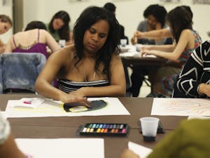 Global studies major Daleah Wilkerson paints at Healing Arts Night, hosted by Rethink: Psychiatric Illness in the Student Union on Tuesday.