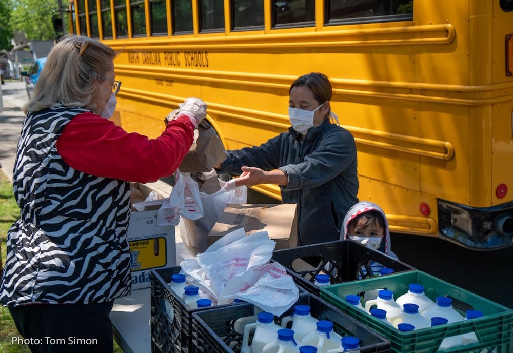 Food is bagged and loaded onto the school bus as part of the Food for Students Program. Photo by Tom Simon.