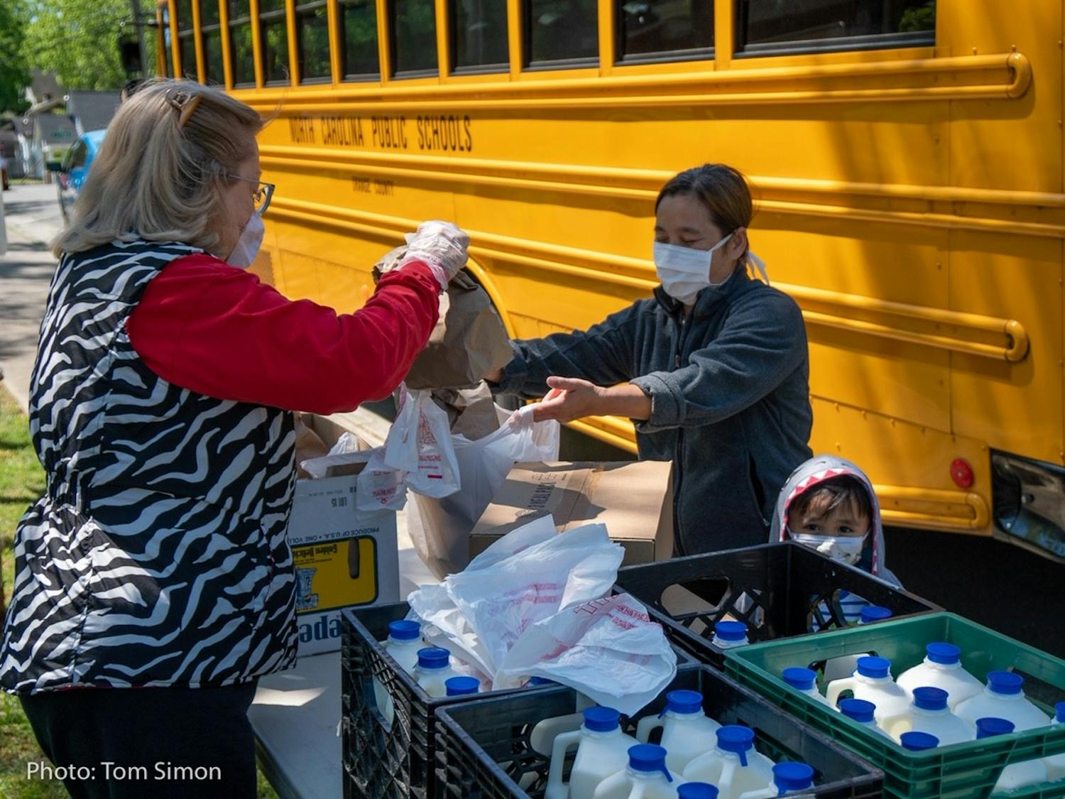 Food is bagged and loaded onto the school bus as part of the Food for Students Program. Photo by Tom Simon.